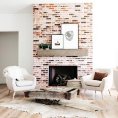 Bright Living Room With Wood Flooring and Brick Fireplace
