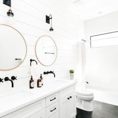 Brass Accents in Dramatic, Black and White Guest Bathroom