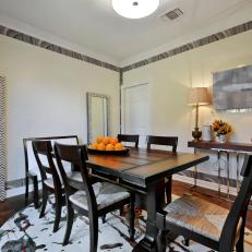 Dining Room With Circle Rug and Patterned Wallpaper Trim