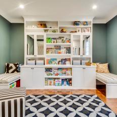 Contemporary Kids Playroom With Large White Bookshelf