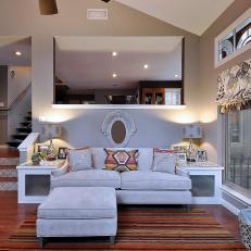 Bonus Room With Gray Couch, Multi-Color Striped Rug