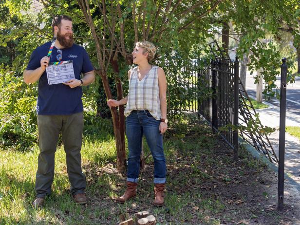 As seen on Home Town, Ben and Erin Napier (C) goof around outside with the slate board before working on the next scene in the front exterior of the Walker residence. Cameraman James Duhon (R) prepares to film the scene. (behind the scenes)