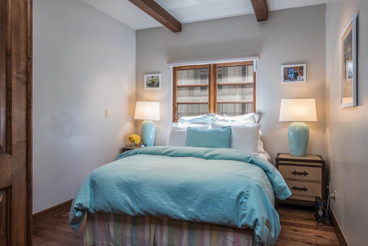  Small  Bedroom  With Blue  Linens and Exposed Ceiling Beams 