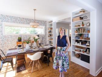 As seen on Home Town, host Erin Napier (C) stands in the large cased opening between the Walkers newly renovated dining room and kitchen. After the renovations, the Walker's Laurel, MS dining room now flows right into the large kitchen and features the original hardwood floor, updated furnishings, a custom built white oak buffet table and a custom designed wallpaper wall that host Erin Napier hand drew and sent off to have the wallpaper created for the Walker residence. (portrait)