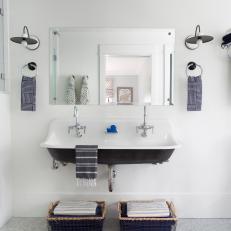 White Country Bathroom With Double Floating Sink, Basket Storage and Contemporary Sconces