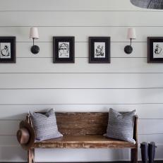 Distressed Natural Wood Bench Over White Shiplap Wall With Black and White Photos 