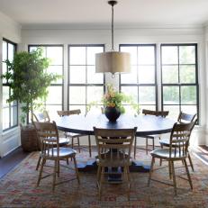 Sunny Country Dining Room With Circular Table, Area Rug and Natural Lighting