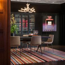 Black Dining Room with Vibrant Striped Rug