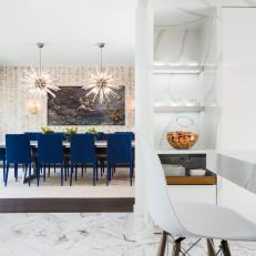 White Kitchen and Dining Room With Blue Chairs