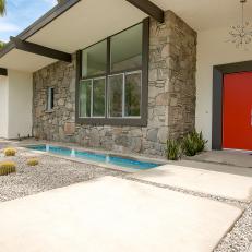 Midcentury Ranch Home With Red Front Door and Stone Walkway