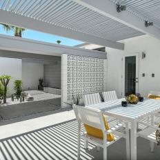 Modern Patio With Pergola and White Table