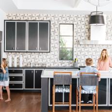 Black and White Chef Kitchen With Blue Stools