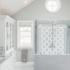 Gray and White Master Bathroom With Round Window