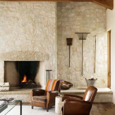 Stone Fireplace and Two Leather Armchairs