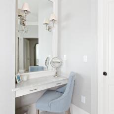 Vanity With Light Blue Chair in Master Bathroom