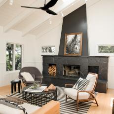 Black Fireplace is Focal Point in Black and White Living Room