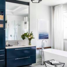 Blue and White Bathroom With Blue Drawers