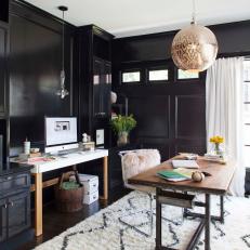 Glamorous Black Home Office With Pendant Light and White Rug