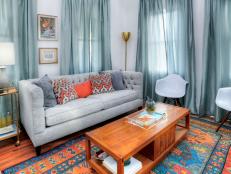 Blue Living Room with Orange and Blue Rug and Gray Sofa 