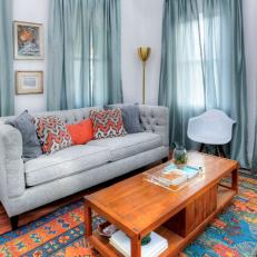 Contemporary Blue Living Room with an Orange and Blue Rug