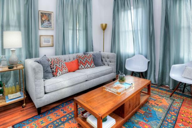 Blue Living Room with Orange and Blue Rug and Gray Sofa 