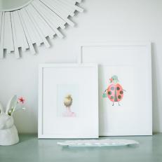 Desktop Details Featuring White Matted Prints, Contemporary Mirror Frame and Colorful Books