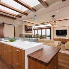 Modern, Neutral Open Kitchen With Exposed Beams, Large Island and Wood Details
