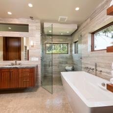 Neutral Modern Master Bathroom With Glass Door Shower and Wood Cabinetry 