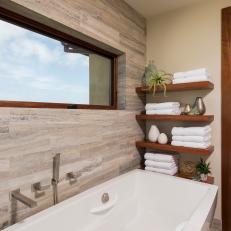 Modern Floating Shelves Over White Bathtub With Neutral Travertine Wall Tile 