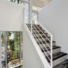 Modern Staircase With Hand Scraped Oak Steps and Sharp White Handrail 