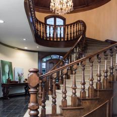 Grand Wood Spiral Staircase With Wool Carpet Steps and High Paneled Wood Ceiling 