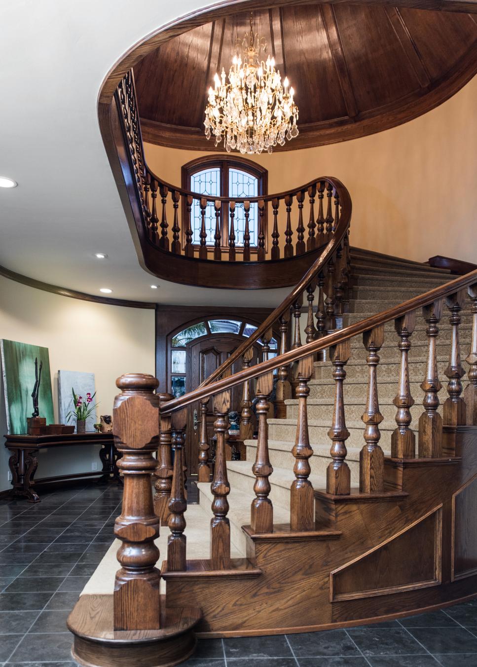 Grand Wood Spiral Staircase With Wool Carpet Steps and High Paneled