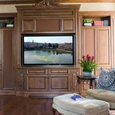Large, Traditional Entertainment Center With Cabinet Storage and Neutral Armchair With Matching Ottoman