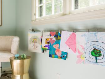 Sleek, easy-to-install curtain wire with hooks make it easy for kids to swap out pieces of all shapes and sizes.