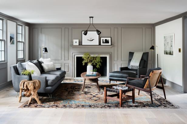 A modern luxury living room with a black sofa, paired with a dark