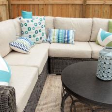 Contemporary Neutral Outdoor Seating Area with Blue and Green Pillows 
