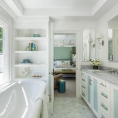 White Master Bathroom With Blue Cabinets