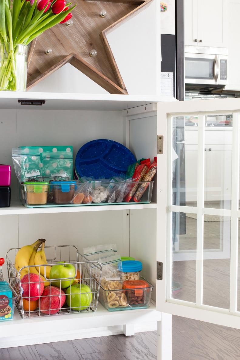 Strategically place go-to snacks, utensils and dishware in lower cabinets and drawers so that your little ones can help themselves when appropriate.
