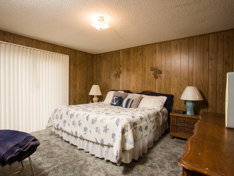 The downstairs bedroom of Drew Scott's home in Galveston, TX before renovations, as seen on Brother vs Brother. This interior shows dark wood paneling and shag carpeting. (Before #6)