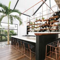 Industrial Shelves Appear to Float Behind Kitchen 