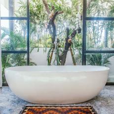 Tropical Bathroom With Tub and Balcony