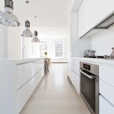 White Modern Kitchen With Industrial Pendants