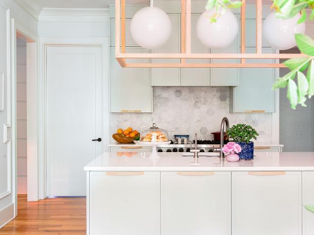 https://hgtvhome.sndimg.com/content/dam/images/hgtv/fullset/2017/6/22/2/Original_Tomas-Espinoza-Angela-Blehm-mint-kitchen-cabinets-pink-flowers-croissants-globes-green-leaves.jpg.rend.hgtvcom.616.462.suffix/1498219093119.jpeg