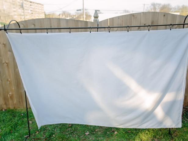 Secure the top of the screen with curtain hangers.