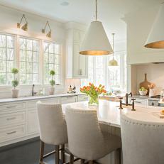 White Eat-In Kitchen With Large Island and Pendant Lights