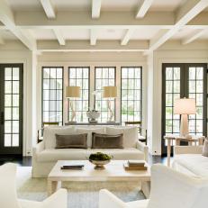 Living Room With Sofas, Tall Windows and Exposed Beam Ceiling