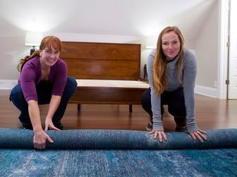 Karen E. Laine (l) and Mina Starsiak roll out a rug in the upstairs master bedroom as seen on Good Bones.(action)