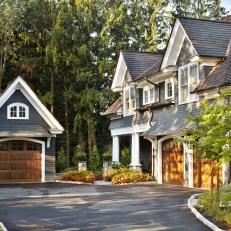 Driveway and Garage of Tudor-Style Home With Gray Shingles