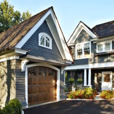 Tudor-Style Home With Copper Roofing Covered in Gray Shingles