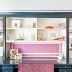 Deep Blue Built In Shelving Unit With White Shelves and Raspberry Accent Wall 